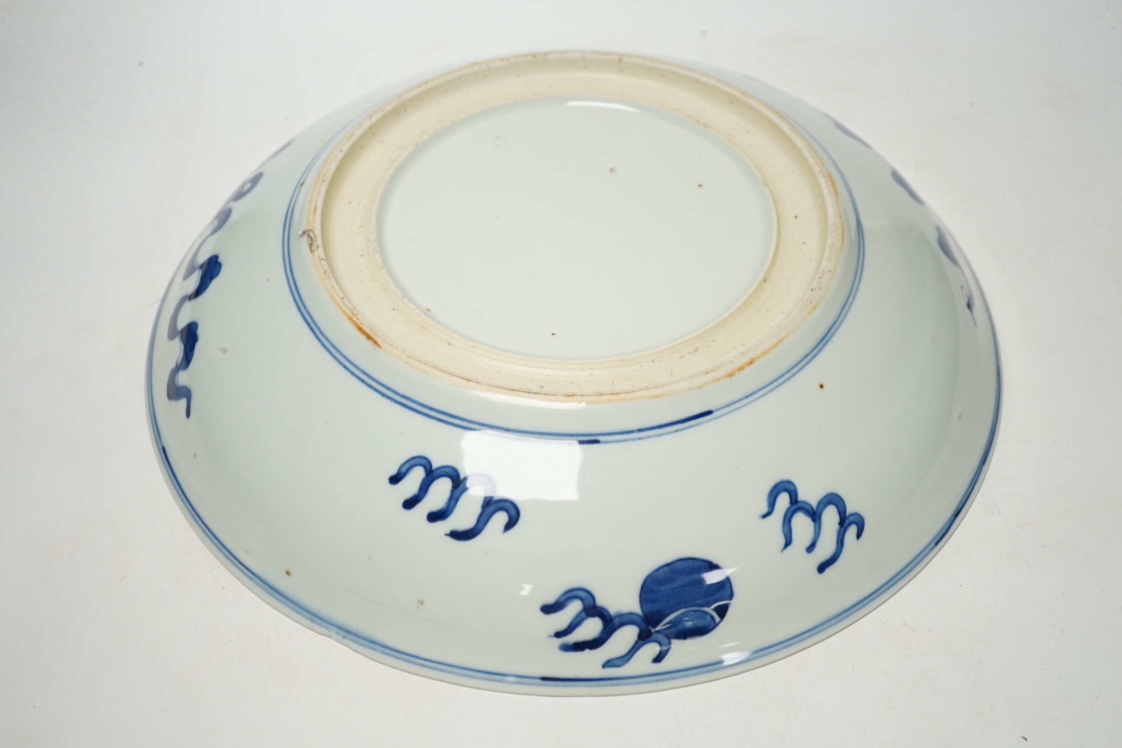 A Chinese blue and white ‘Buddhist lion’ dish, channel moulded foot, 36cm diameter